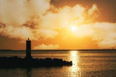 日落 黄色的天空 云 灯塔 海洋 引人注目 黄昏 湖 草 此刻